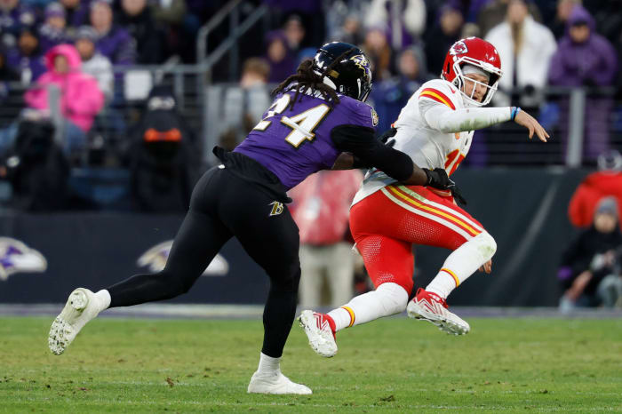 Jan 28, 2024; Baltimore, Maryland, USA; Kansas City Chiefs quarterback Patrick Mahomes (15) is knocked down after passing the ball by Baltimore Ravens linebacker Jadeveon Clowney (24) in the AFC Championship football game at M&T Bank Stadium.